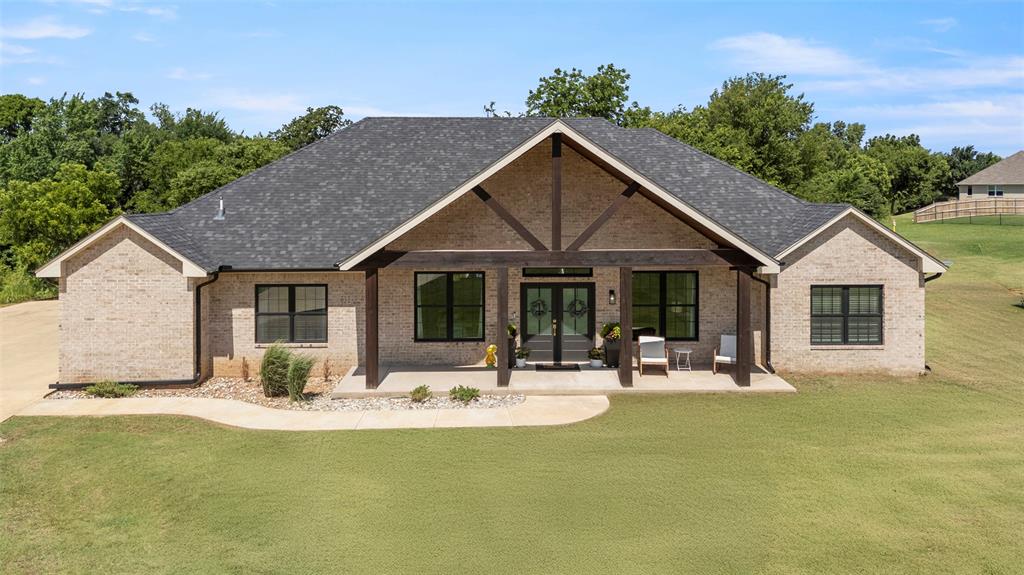 Tessa Hood Realtor – Custom 2022 brick home with cedar beam covered porch at 1074 Fawn Meadow Dr, Blanchard Oklahoma