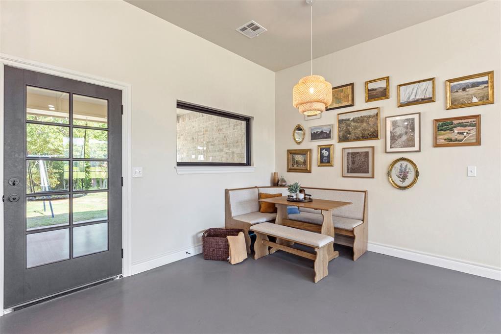 Tessa Hood Realtor – Breakfast nook with built-in booth seating, pendant light, and gallery wall at 1074 Fawn Meadow Dr, Blanchard Oklahoma