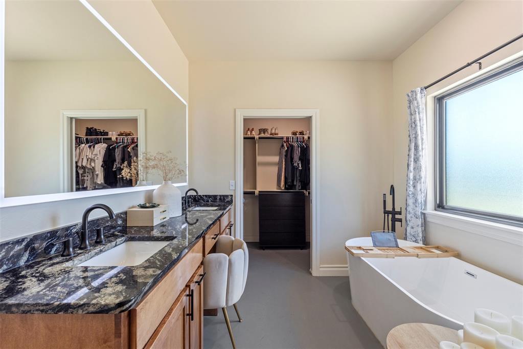 Tessa Hood Realtor – Primary bathroom with dual vanity, freestanding soaking tub, and dual walk-in closets at 1074 Fawn Meadow Dr, Blanchard Oklahoma