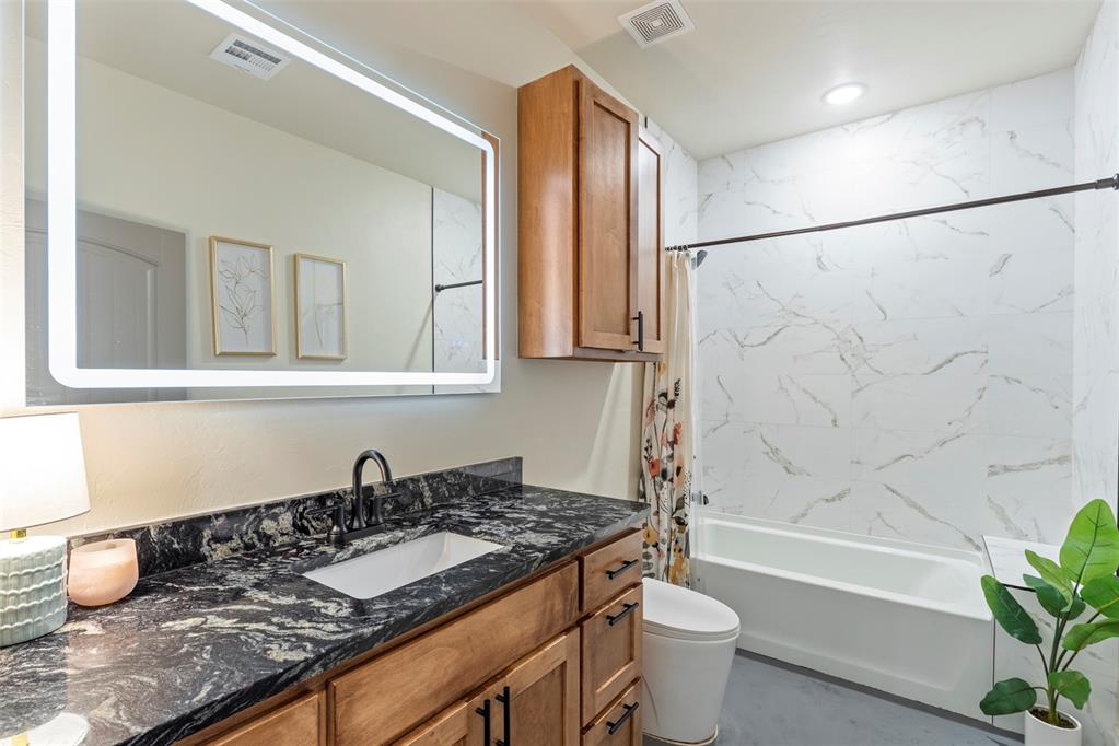 Tessa Hood Realtor – Secondary bathroom with granite vanity, LED mirror, and marble-surround tub-shower at 1074 Fawn Meadow Dr, Blanchard Oklahoma