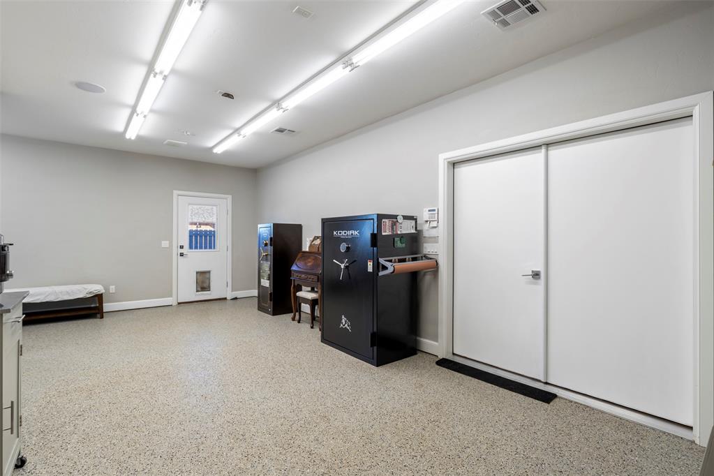 Tessa Hood Realtor – 3-car garage interior with epoxy floors and safe at 516 Kings Ct, Tuttle Oklahoma