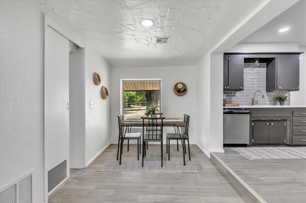 Tessa Hood Realtor – Dining area and updated kitchen with dark grey cabinets and subway tile at 7400 Lakewood Dr, Mustang Oklahoma