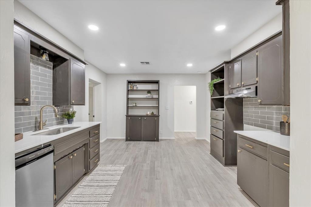 Tessa Hood Realtor – Full galley-style kitchen view with updated cabinets on both sides at 7400 Lakewood Dr, Mustang Oklahoma