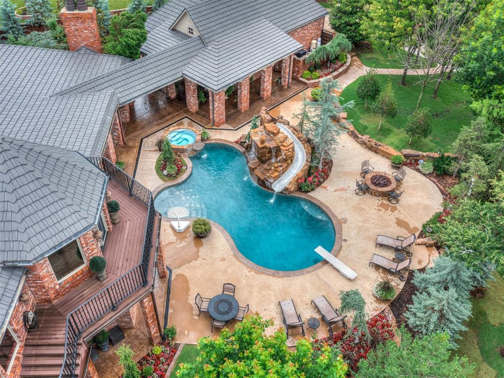 Tessa Hood Realtor – Resort-style pool with waterfall slide and hot tub at 1705 Maple Dr, Blanchard Oklahoma