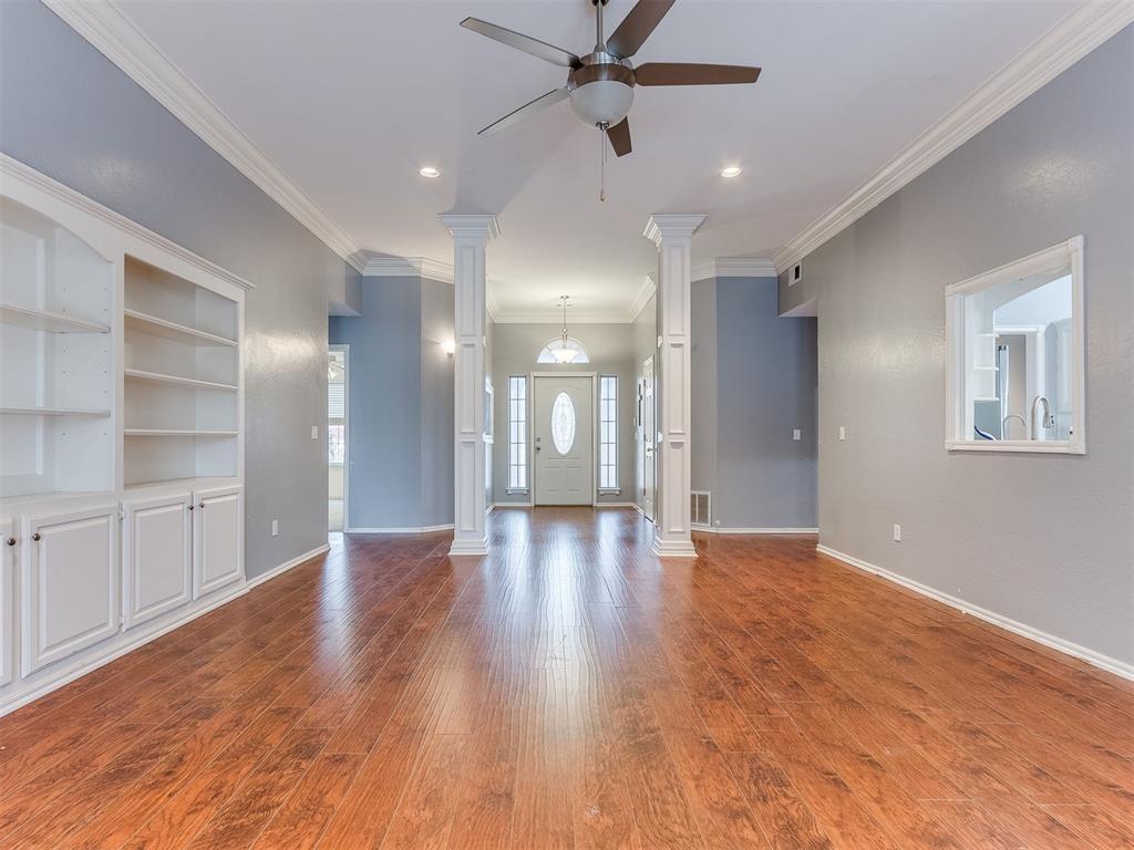 Tessa Hood Realtor – Open living room with columns, built-ins, and view to entry at 5879 Mockingbird Ln, Blanchard Oklahoma