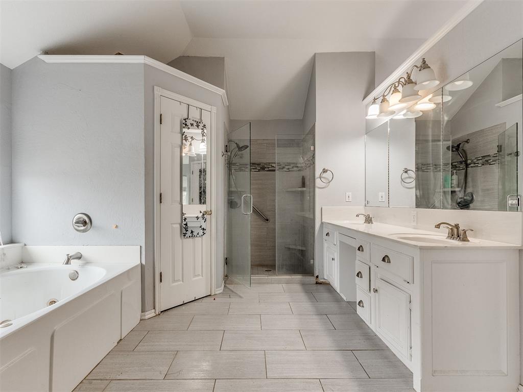 Tessa Hood Realtor – Primary bathroom with soaking tub, separate glass shower, and double vanity at 5879 Mockingbird Ln, Blanchard Oklahoma