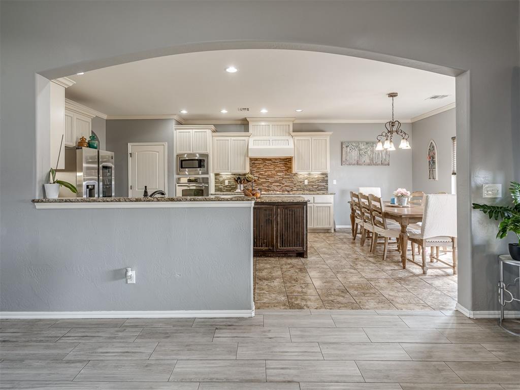 Tessa Hood Realtor – Kitchen and dining room seen through archway at 5708 SE 148th St, Oklahoma City OK