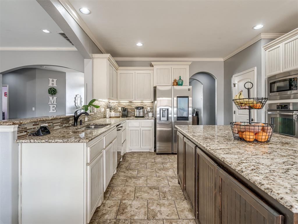 Tessa Hood Realtor – Kitchen with stainless steel appliances and granite counters at 5708 SE 148th St, Oklahoma City OK