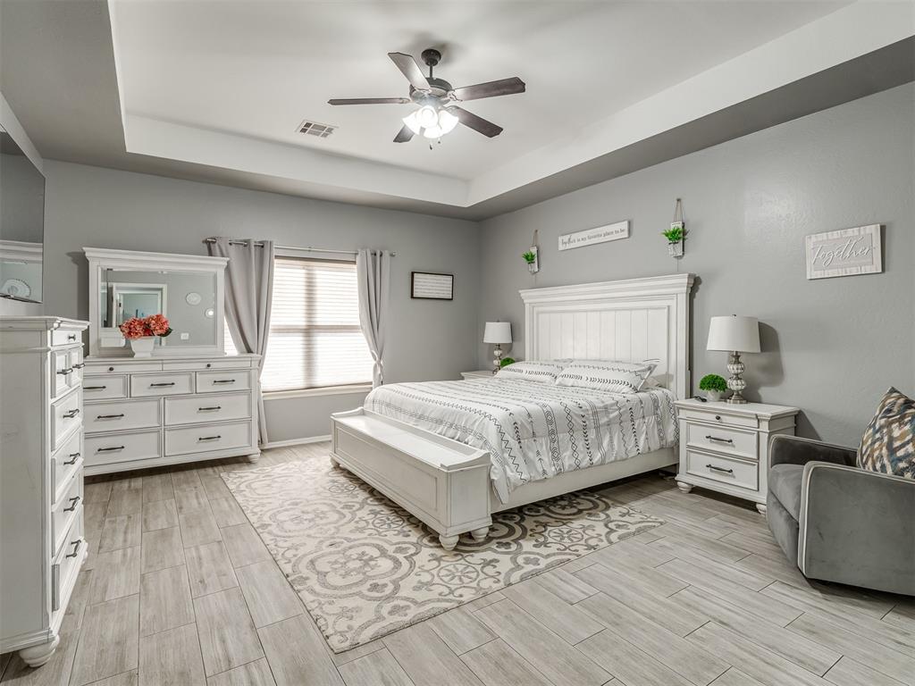 Tessa Hood Realtor – Primary bedroom with tray ceiling and ceiling fan at 5708 SE 148th St, Oklahoma City OK