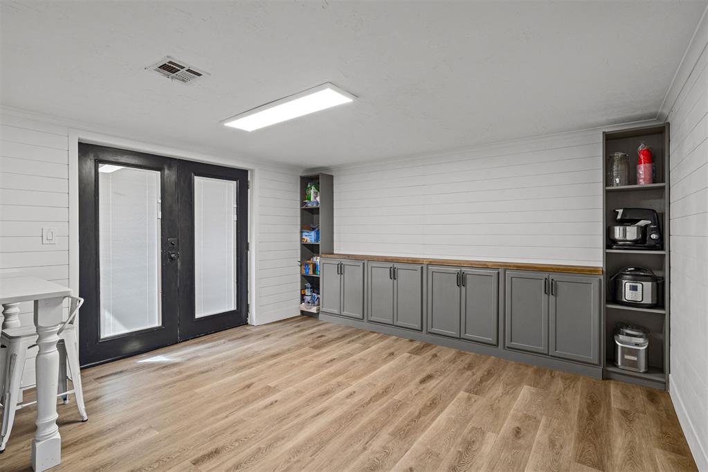 Tessa Hood Realtor – Dining area with shiplap walls and gray cabinetry at 21063 State Hwy 76, Blanchard Oklahoma