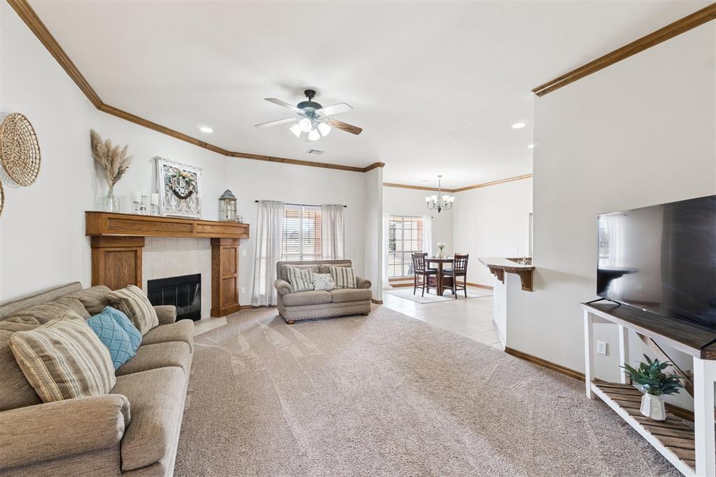 Tessa Hood Realtor – Spacious living room with wood-mantel fireplace and open dining view at 1928 SW 9th St, Newcastle Oklahoma