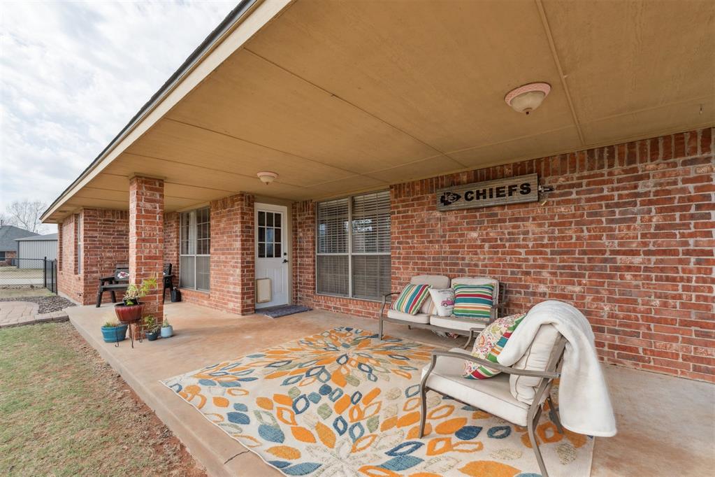 Tessa Hood Realtor – Covered back patio with brick columns and fenced yard at 1928 SW 9th St, Newcastle Oklahoma