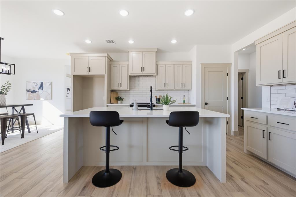 Tessa Hood Realtor – Kitchen with large island and custom cabinetry at 2439 Wind River Cir, Blanchard Oklahoma