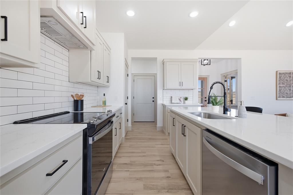 Tessa Hood Realtor – Kitchen with stainless appliances and subway tile backsplash at 2439 Wind River Cir, Blanchard Oklahoma